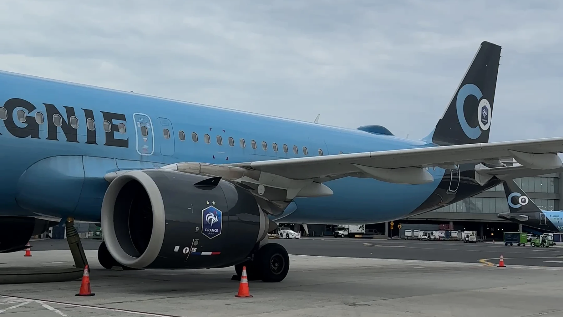 Blue La Compagnie Airbus A321 on the ramp, showing the engine, wing, fuselage and tail.